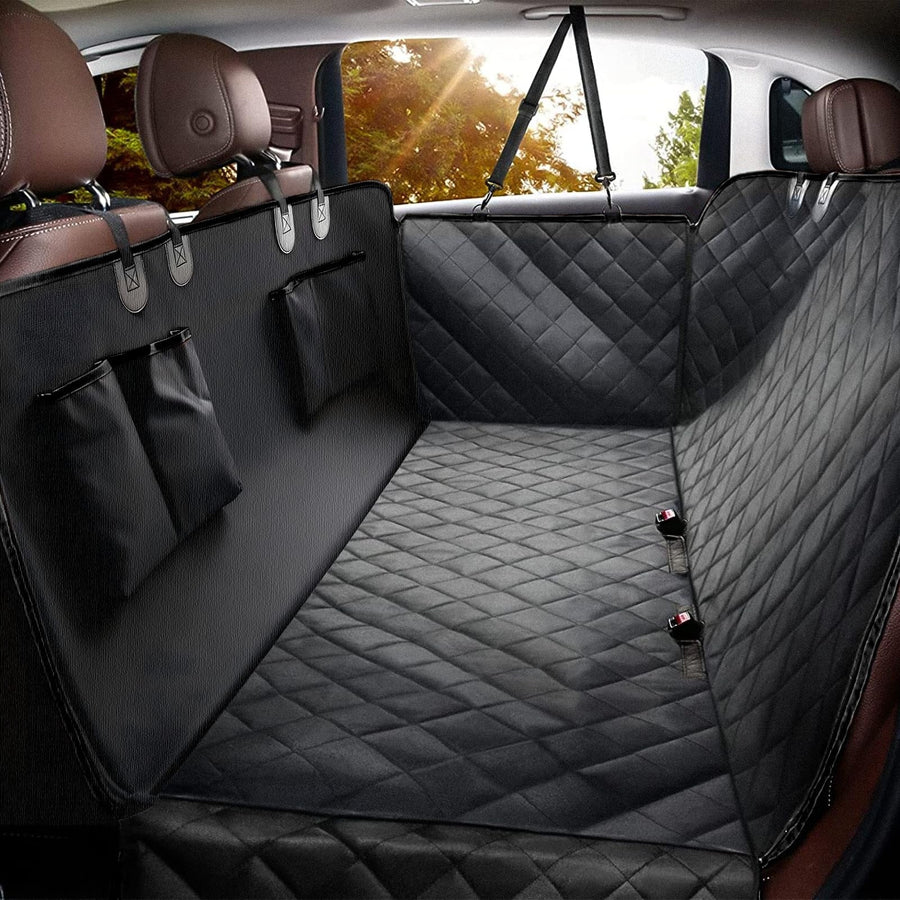 Dewspell Backseat Buddy all-black quilted dog car seat cover installed as a hammock across the back seat