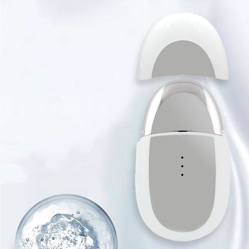 Dewspell Warm Eye Reset Massager — handheld skincare use