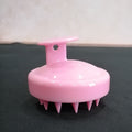 Pink Dewspell scalp massage brush with soft silicone bristles