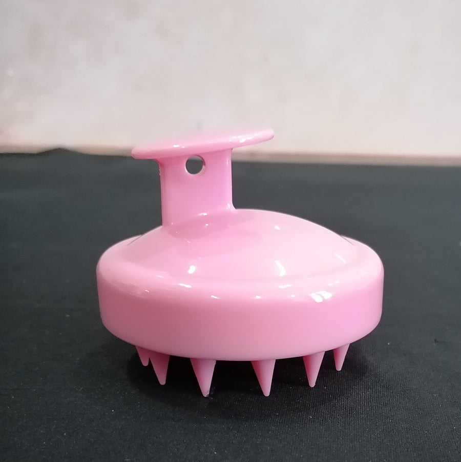 Pink Dewspell scalp massage brush with soft silicone bristles
